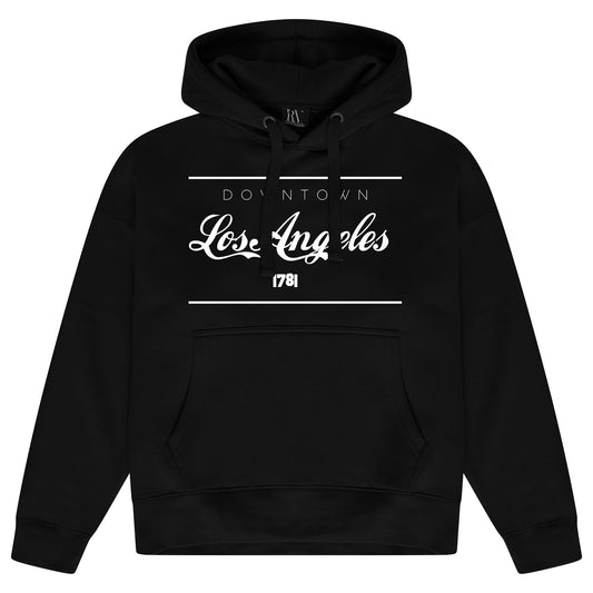 Black oversized women’s hoodie featuring a bold Los Angeles graphic printed centrally on the chest, with an adjustable drawstring hood, ribbed cuffs, and hem. 