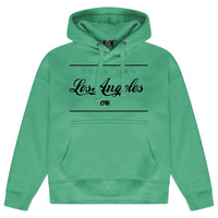 Green oversized women’s hoodie featuring a bold Los Angeles graphic printed on the front, adjustable drawstring hood, long sleeves, and ribbed cuffs and hem.