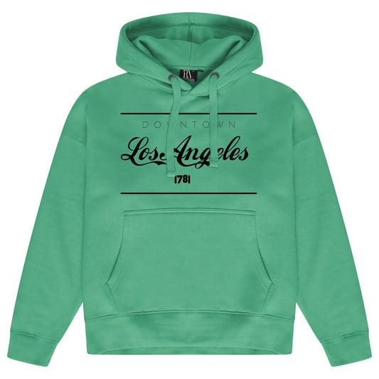 Green oversized women’s hoodie featuring a bold Los Angeles graphic printed on the front, adjustable drawstring hood, long sleeves, and ribbed cuffs and hem.