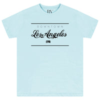 Turquoise oversized women’s T-shirt featuring a bold “Los Angeles” graphic printed prominently across the front, classic round neckline, and short sleeves.