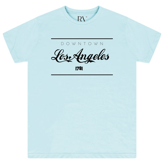 Turquoise oversized women’s T-shirt featuring a bold “Los Angeles” graphic printed prominently across the front, classic round neckline, and short sleeves.