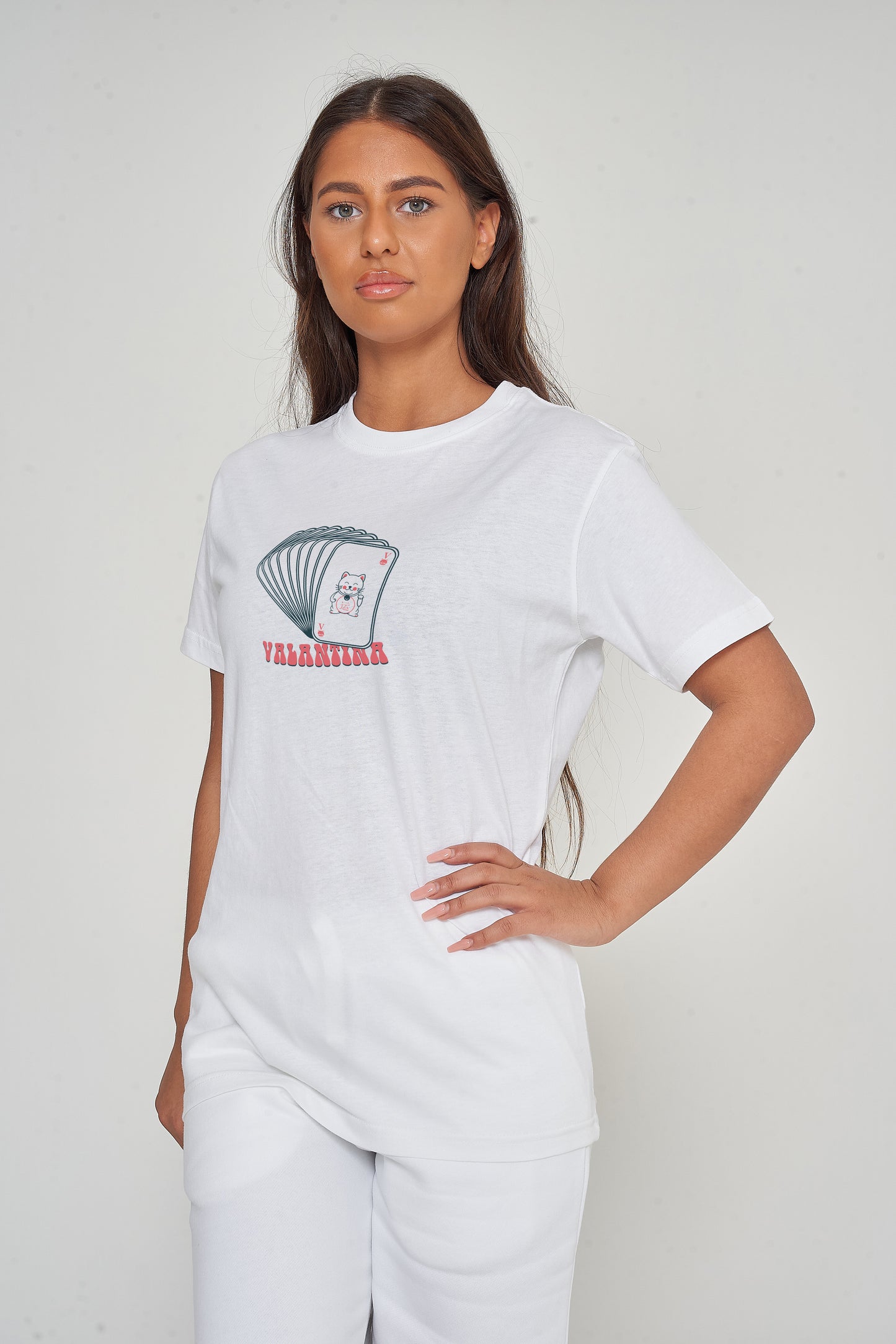 Woman wearing the Lucky Cards Oversized T-Shirt styled with casual bottoms, highlighting the striking front graphic and comfortable oversized silhouette.