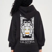 Woman wearing the Medusa Oversized Hoodie (black), styled with casual bottoms, highlighting the large back graphic and comfortable silhouette.