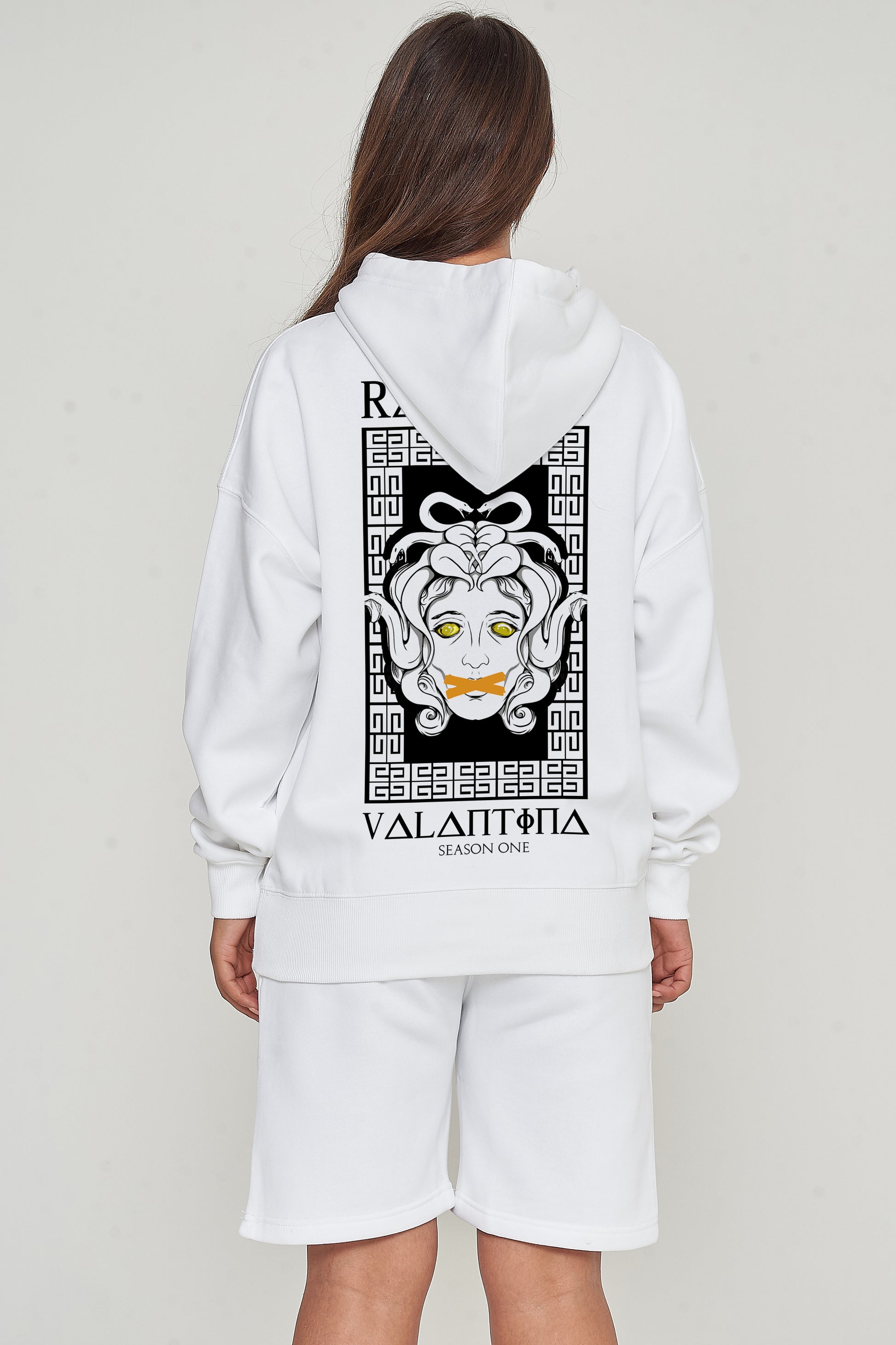 Woman wearing the Medusa Oversized Hoodie (white), styled with casual bottoms, highlighting the dramatic back graphic and comfortable, relaxed fit.