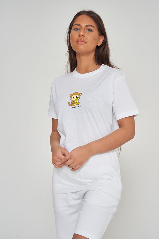 Woman wearing the white Monkey Graphic T-Shirt styled with casual bottoms, highlighting the prominent front monkey print and comfortable oversized fit. 
