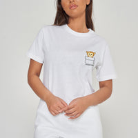 Woman wearing the white Monkey Pocket T-Shirt styled with casual bottoms, highlighting the playful front monkey graphic and comfortable oversized fit. 
