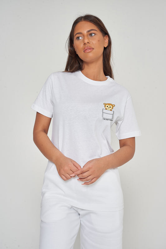 Woman wearing the white Monkey Pocket T-Shirt styled with casual bottoms, highlighting the playful front monkey graphic and comfortable oversized fit. 