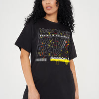 Woman wearing the black New York Season 1 Oversized T-Shirt styled with casual bottoms, highlighting the front graphic and comfortable oversized fit.