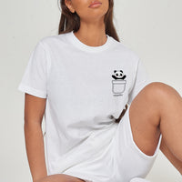 Woman wearing the white Panda Pocket T-Shirt styled with casual bottoms, highlighting the playful front panda graphic and comfortable oversized fit.