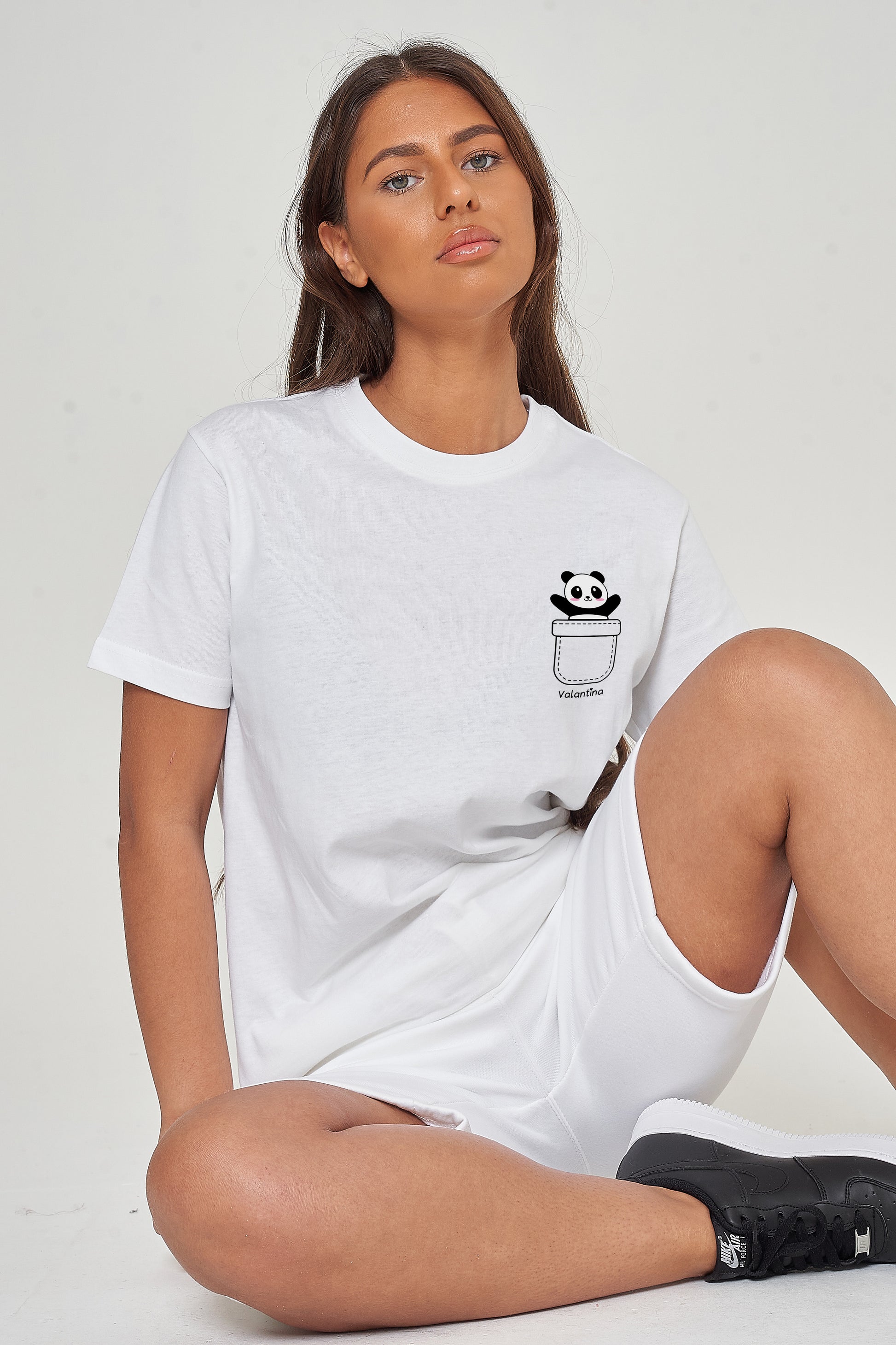 Woman wearing the white Panda Pocket T-Shirt styled with casual bottoms, highlighting the playful front panda graphic and comfortable oversized fit.