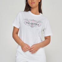 Woman wearing the white Pink Peacock Oversized T-Shirt styled with casual bottoms, highlighting the vibrant front graphic and comfortable fit.