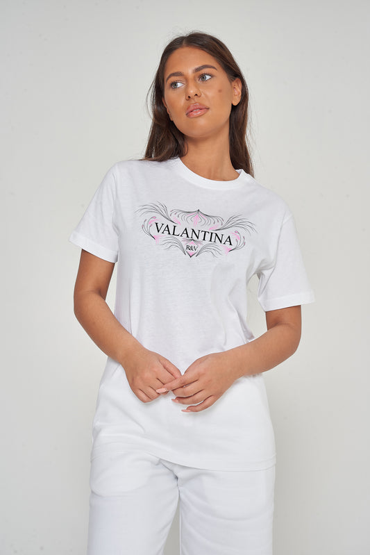 Woman wearing the white Pink Peacock Oversized T-Shirt styled with casual bottoms, highlighting the vibrant front graphic and comfortable fit.