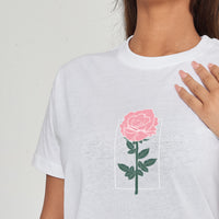 Woman wearing the Plain Rose Oversized T-Shirt styled with casual bottoms, highlighting the subtle front rose print and relaxed comfortable fit.