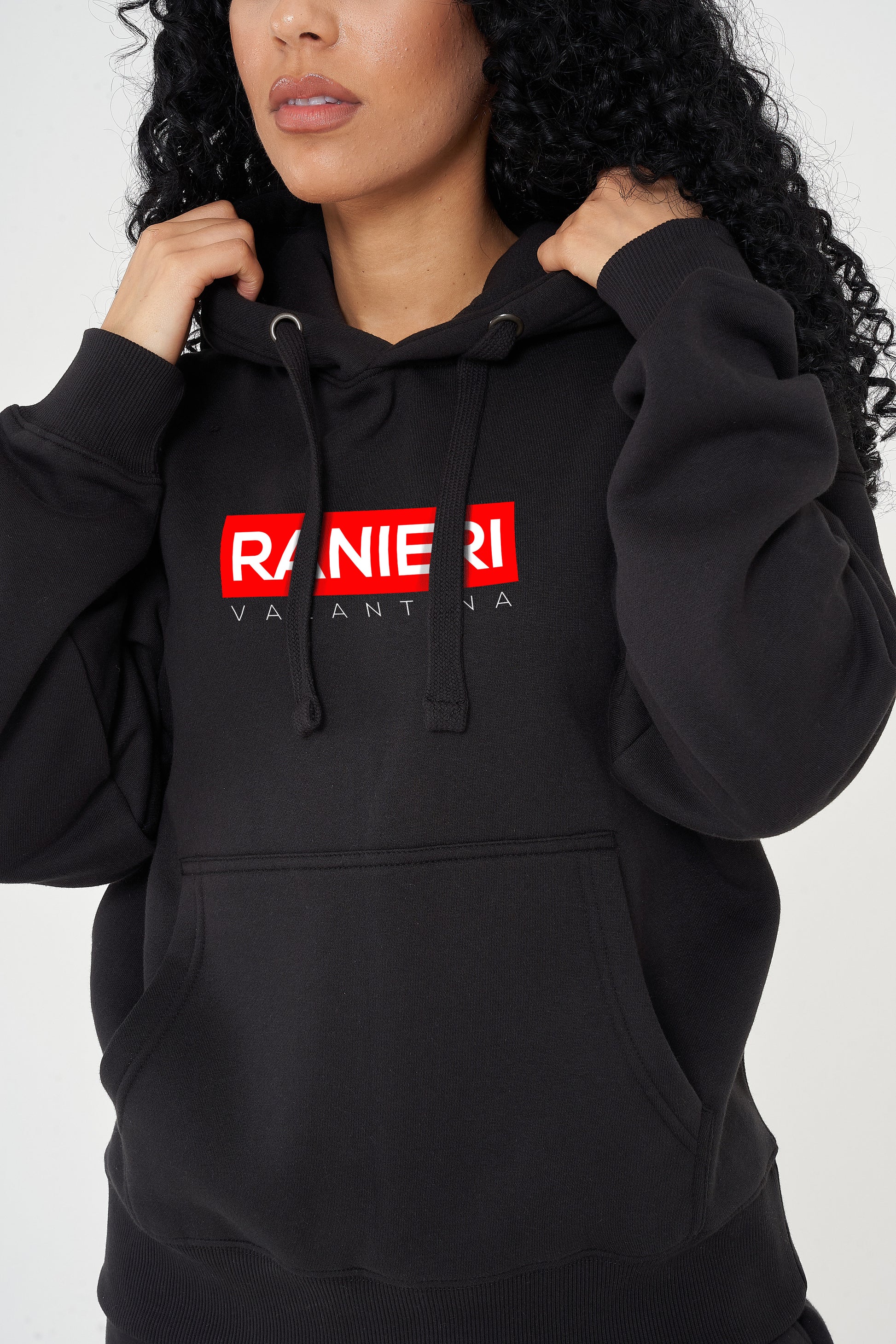 Woman wearing the black Red Box Oversized Hoodie styled with casual bottoms, highlighting the striking front red box print and comfortable, relaxed silhouette.