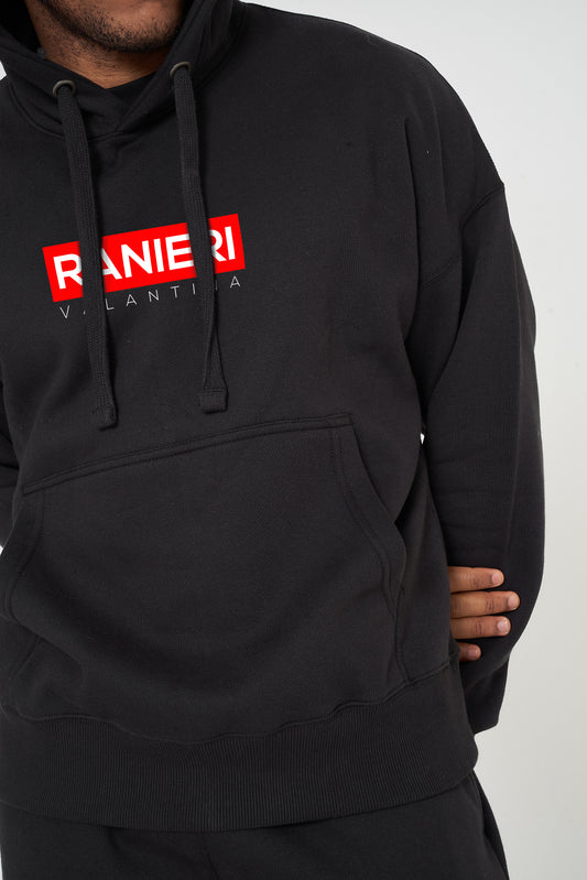 Person wearing the black Red Box Oversized Hoodie styled with casual bottoms, highlighting the front red box graphic and comfortable, roomy silhouette.