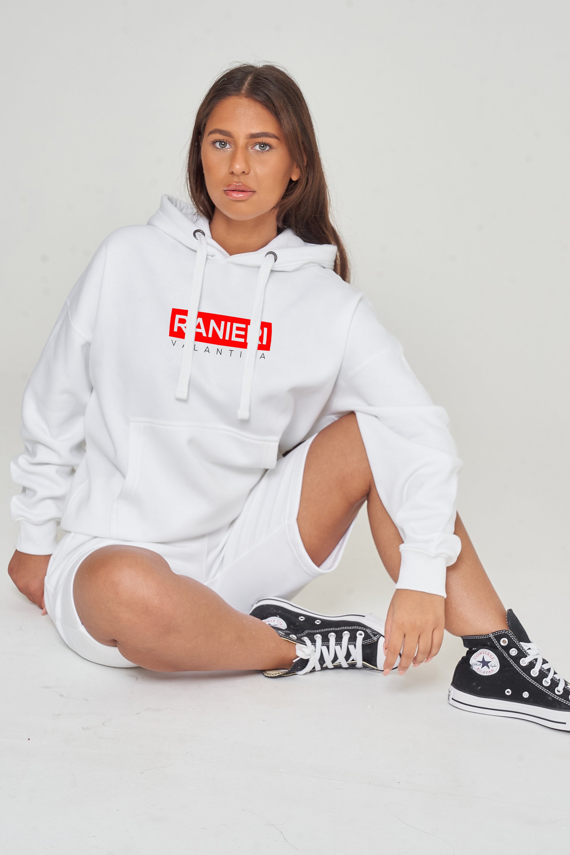 Person wearing the white Red Box Oversized Hoodie styled with casual bottoms, highlighting the front red box print and comfortable oversized silhouette. 