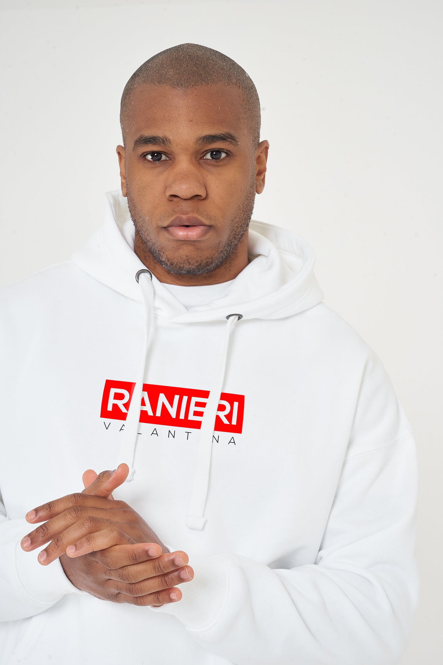 Person wearing the white Red Box Oversized Hoodie styled with casual bottoms, highlighting the front red box print and comfortable oversized silhouette.