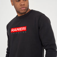 Person wearing the black Red Box Sweatshirt styled with casual bottoms, highlighting the front red box graphic and comfortable fit.