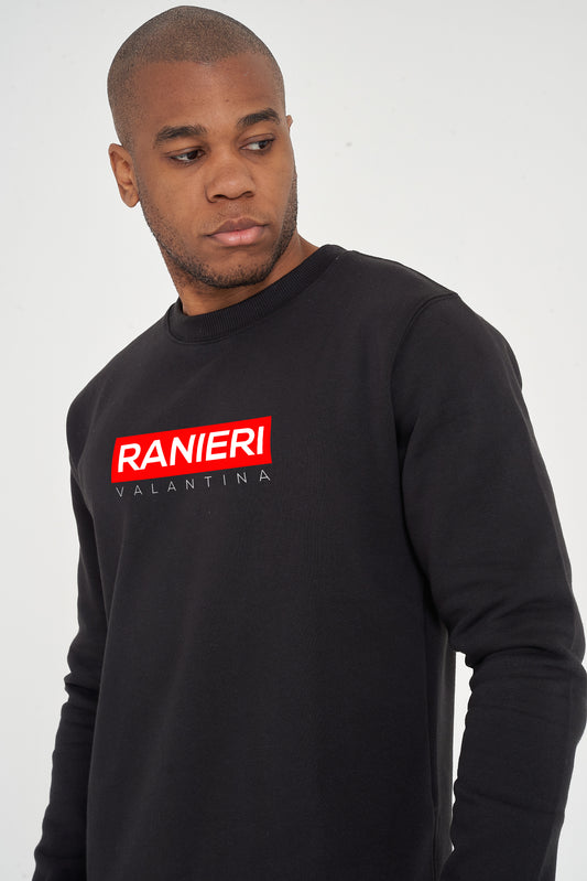 Person wearing the black Red Box Sweatshirt styled with casual bottoms, highlighting the front red box graphic and comfortable fit.