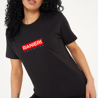 Woman wearing the black Red Box T-Shirt styled with casual bottoms, highlighting the bold front red box graphic and comfortable relaxed fit.