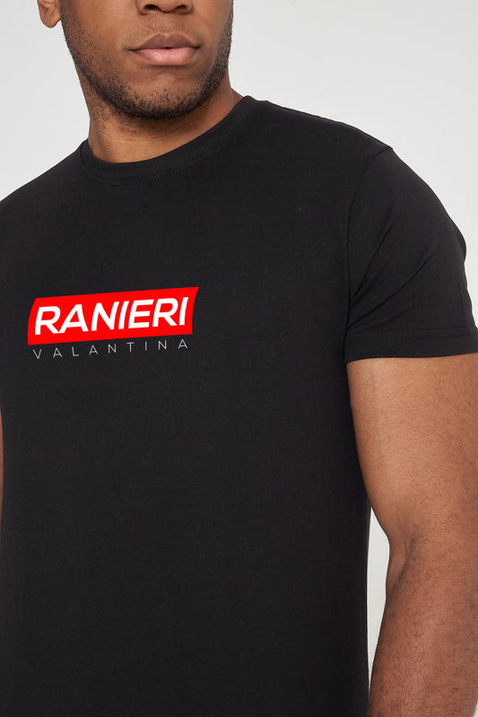 Man wearing the black Red Box T-Shirt styled with casual bottoms, highlighting the bold front red box graphic and comfortable drape.