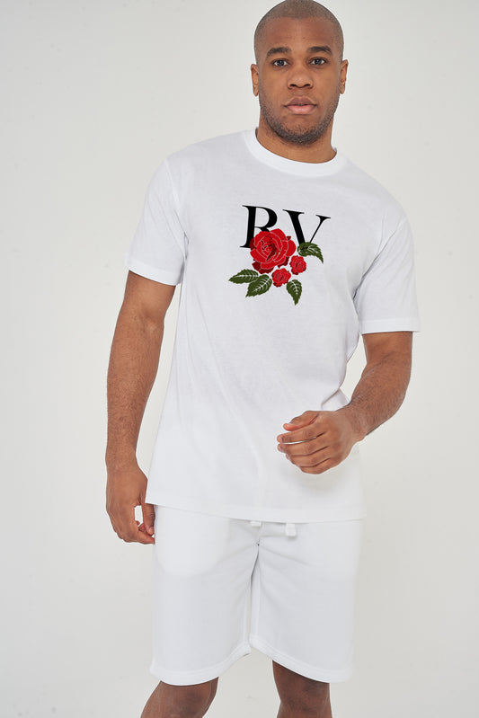 Male model front view wearing white R&V Rose T-shirt with rose graphic, paired with white shorts – regular fit.