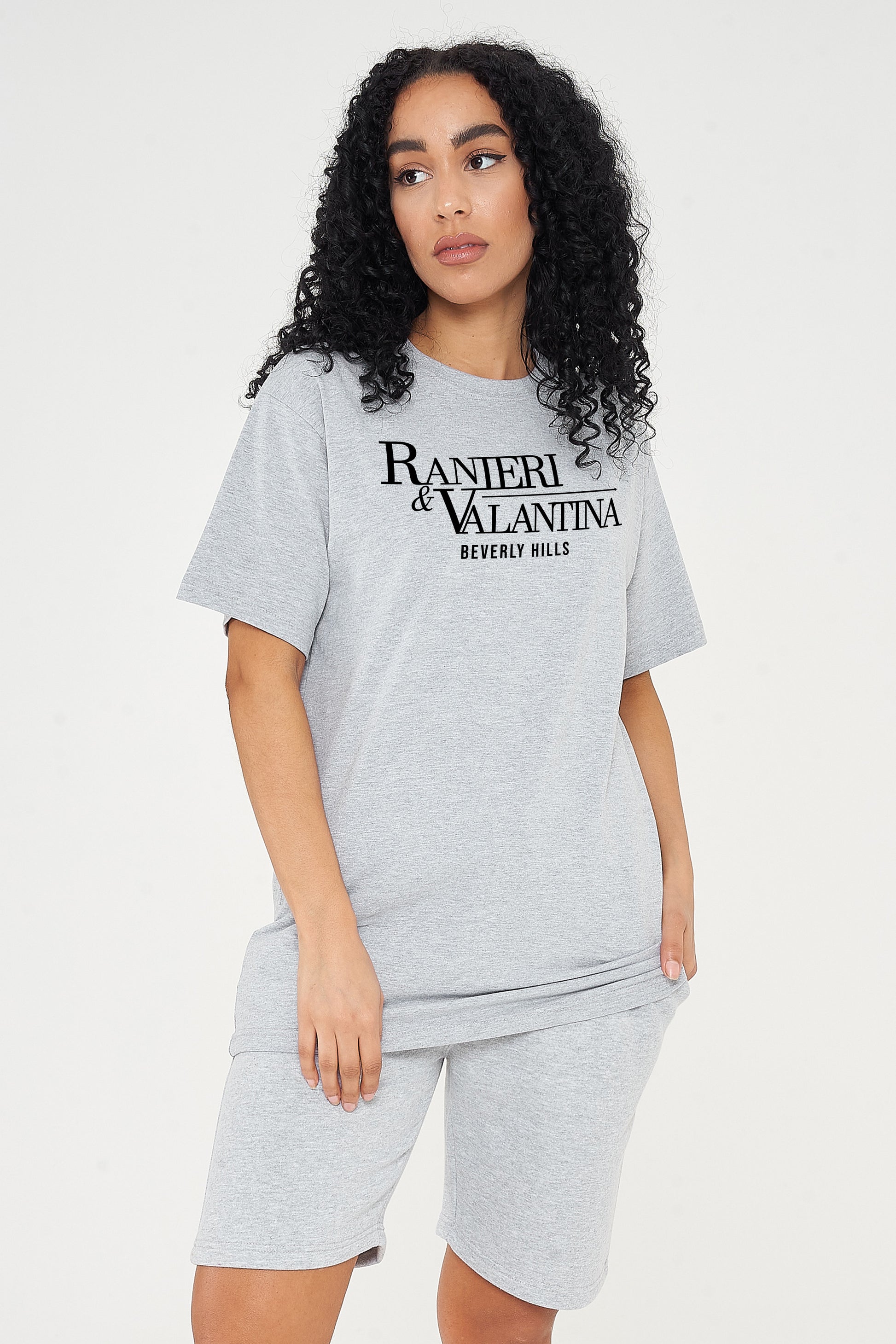 Woman wearing grey oversized Signature Beverly Hills T-shirt and shorts, styled in a modern UK streetwear look.