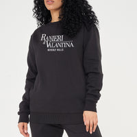 A Woman wearing a black Signature Beverly Hills sweatshirt paired with matching shorts, showcasing UK streetwear style.