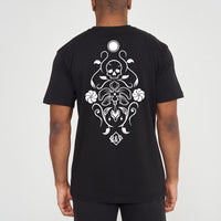 Man wearing the black Skull Tattoo Oversized T-Shirt styled with casual bottoms, showcasing the striking back graphic and comfortable fit.