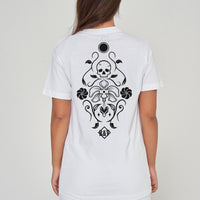 Woman wearing the white Skull Tattoo Oversized T-Shirt styled with casual bottoms, showcasing the back skull graphic and comfortable silhouette.