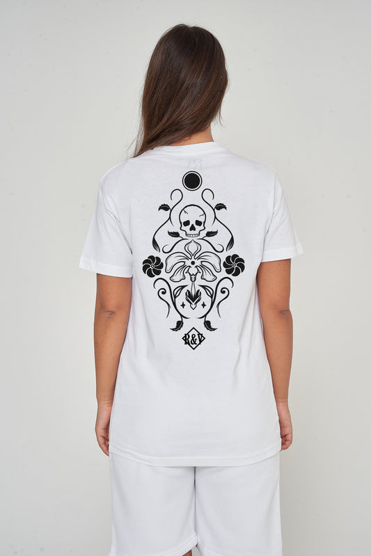 Woman wearing the white Skull Tattoo Oversized T-Shirt styled with casual bottoms, showcasing the back skull graphic and comfortable silhouette.