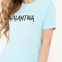 Woman wearing the turquoise Strong Woman Oversized T-Shirt styled with casual bottoms, highlighting the empowering front print and comfortable silhouette.