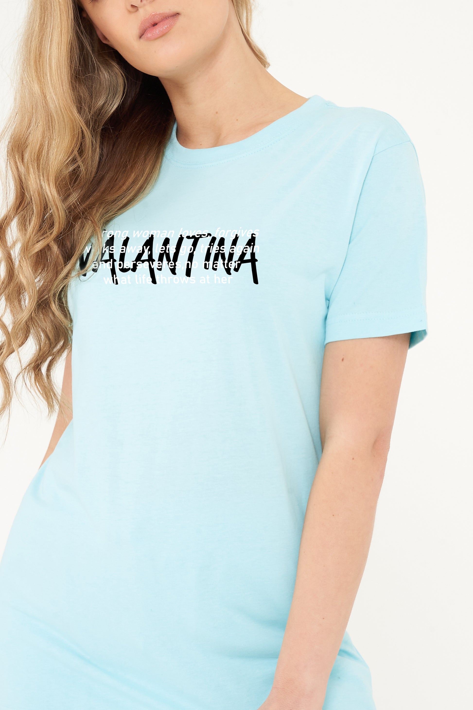 Woman wearing the turquoise Strong Woman Oversized T-Shirt styled with casual bottoms, highlighting the empowering front print and comfortable silhouette.