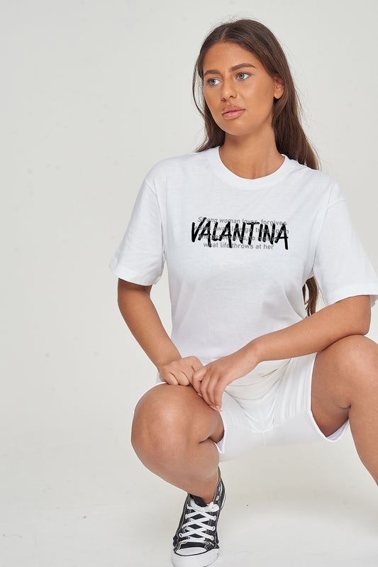 Woman wearing the white Strong Woman Oversized T-Shirt styled with casual bottoms, highlighting the empowering front graphic and comfortable fit.