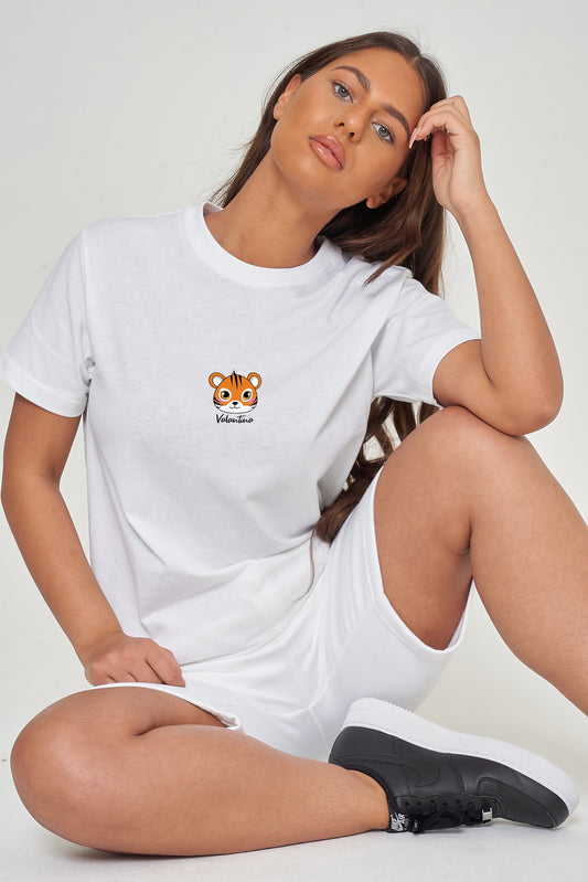 Woman wearing the white Tiger Head T-Shirt styled with casual bottoms, highlighting the prominent front tiger head graphic and comfortable oversized fit.