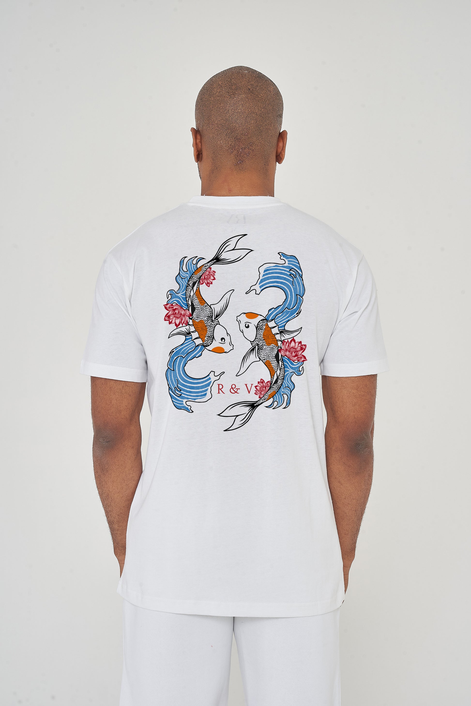 Man wearing the white Twin Koi Oversized T-Shirt styled with casual bottoms, showcasing the striking koi back print and comfortable silhouette.