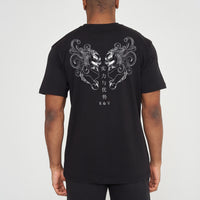  Man wearing the black Twin Lion Oversized T-Shirt styled with casual bottoms, showcasing the striking back graphic and comfortable oversized fit.