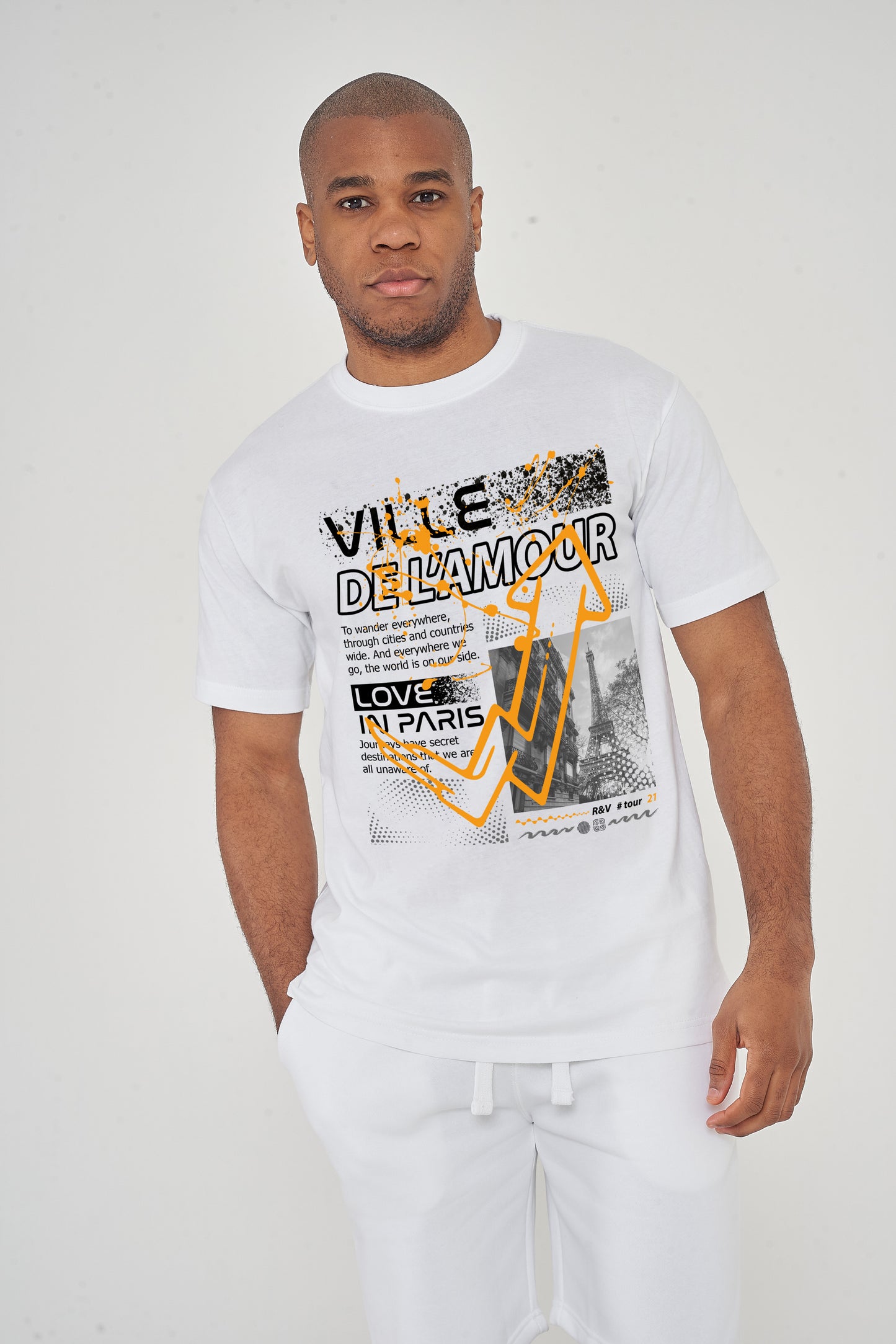 Model front view wearing white oversized Ville De L'amour T-shirt with graphic text, relaxed streetwear style.