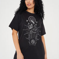 Woman wearing the black Virgo Zodiac Graphic T-Shirt styled with dark denim and casual boots, showcasing the front graphic and relaxed oversized fit.