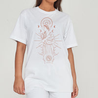Woman wearing oversized white Virgo Zodiac Graphic T-Shirt styled with matching bottoms, showcasing the front graphic and relaxed fit.