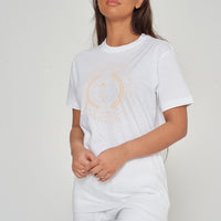 Woman wearing the white Vitruvian T-Shirt styled with casual denim bottoms, highlighting the front artistic print and comfortable oversized fit.