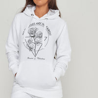 Female model wearing white Wild Roses hoodie and shorts, standing against neutral background.