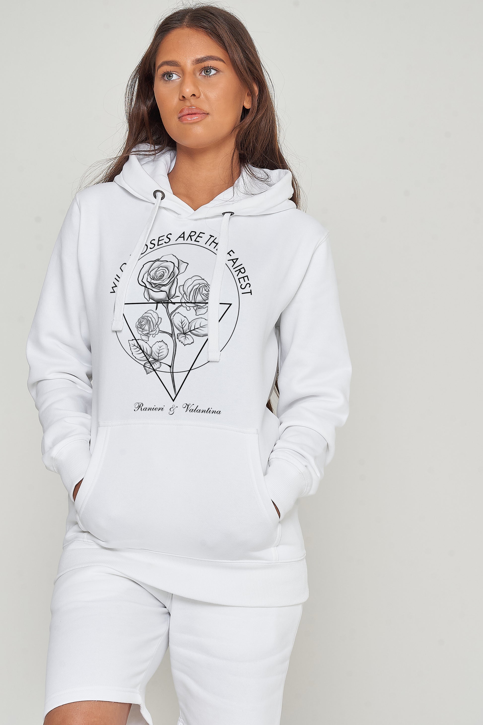 Female model wearing white Wild Roses hoodie and shorts, standing against neutral background.