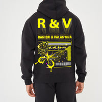 Rear view of male model wearing black oversized hoodie with striking yellow butterfly graphic and R&V print – oversized fit.